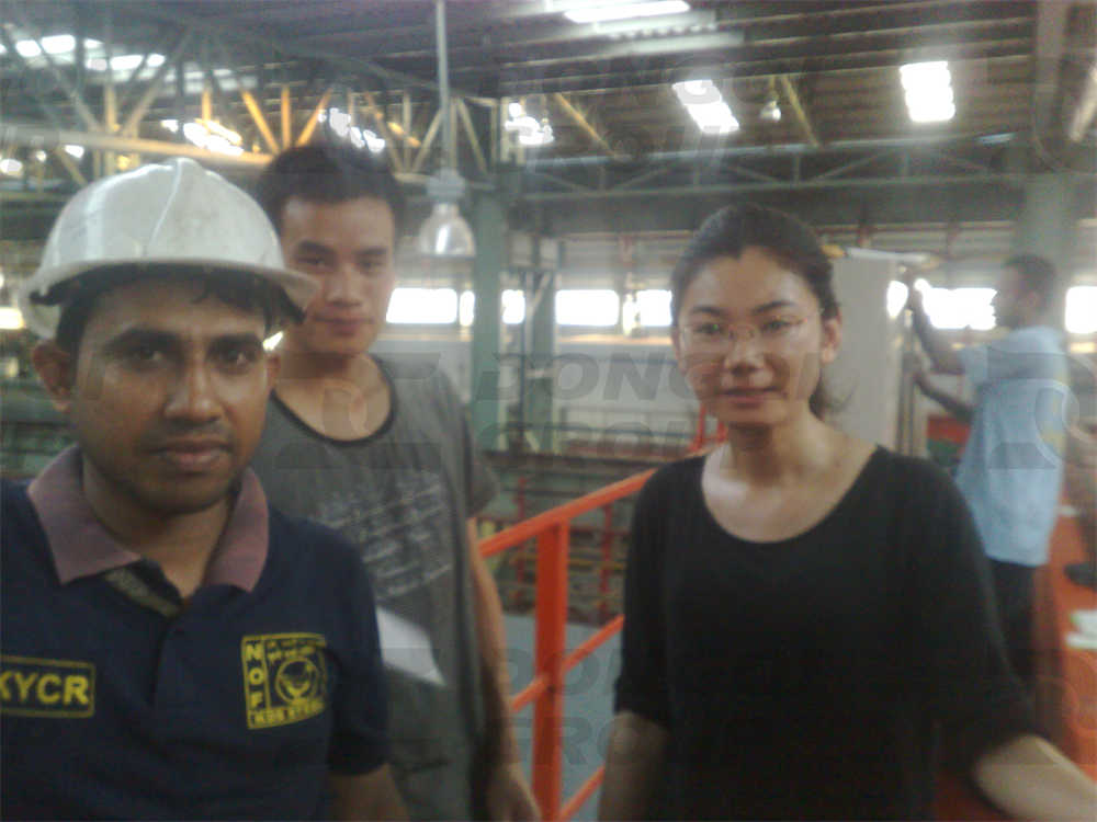 Engineers take photos with Bangladeshi customers in the factory